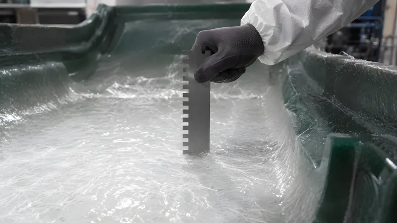 Messkamm prüft die nasse Schichtdicke des gespritzten Laminats an einer Innenfläche der Form